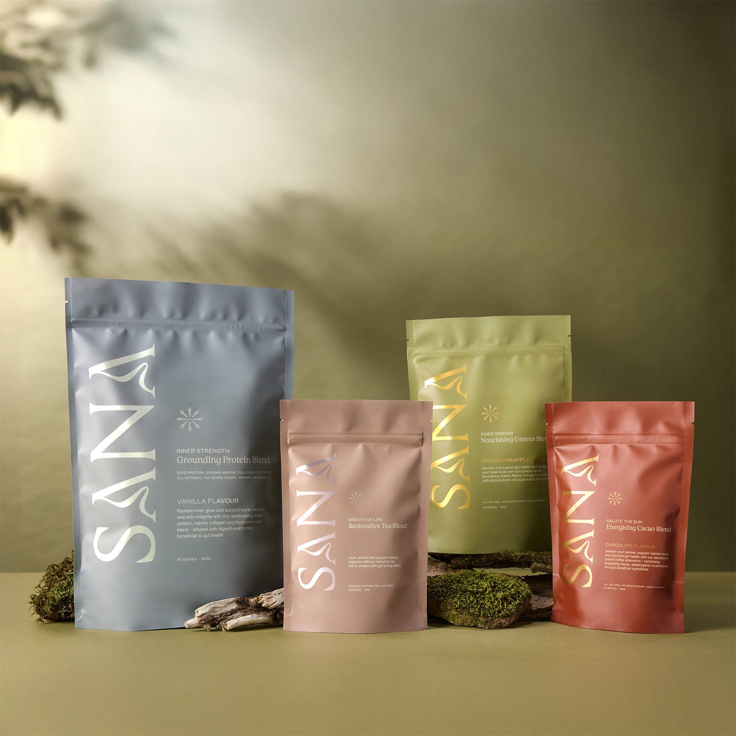 Complete Sana Wellness product collection featuring Grounding Protein Blend, Restorative Tea Blend, Nourishing Greens Blend and Energising Cacao Blend